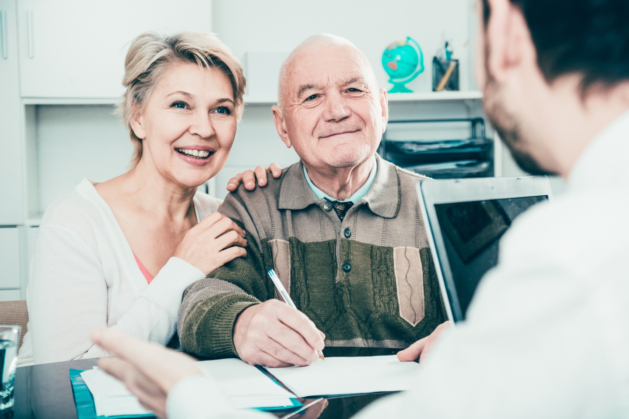 Old man and mature woman consult with Insurance department employee for Insurance Coverage