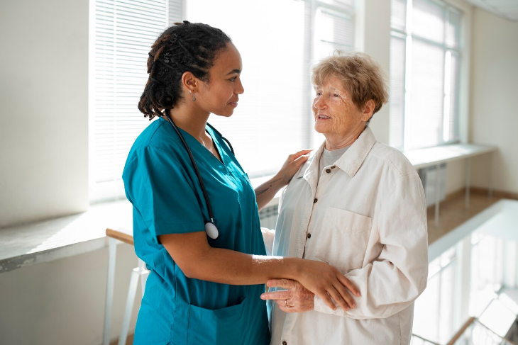 Nurse holding a patient's hand, offering emotional support
