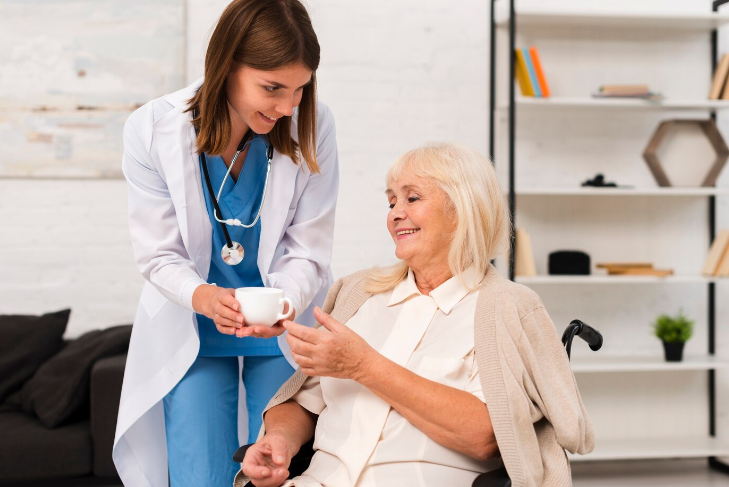 Home and Nursing Care Nurse take care of old women with cup of coffee.